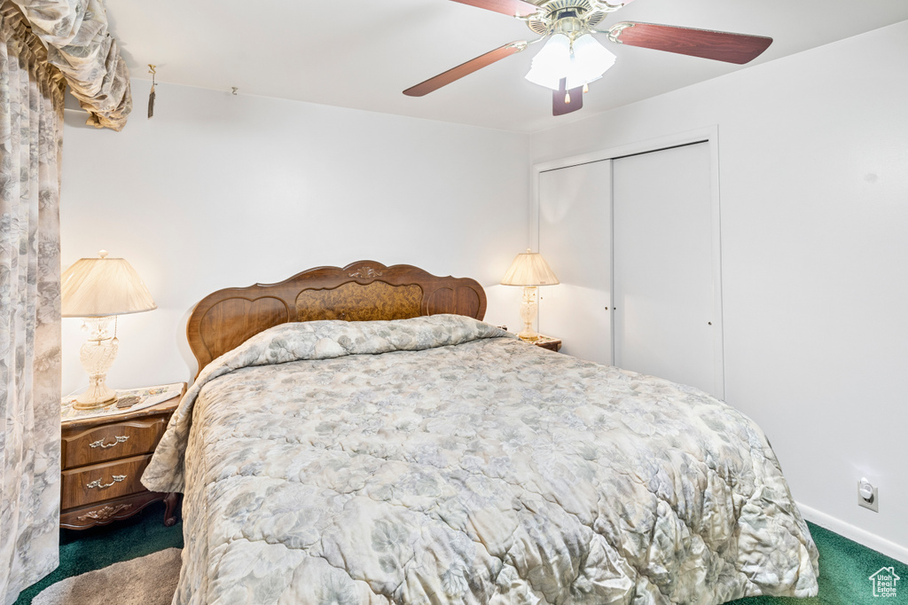 Bedroom featuring dark colored carpet, a closet, and ceiling fan