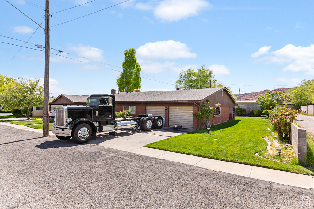 Single story home featuring a front yard