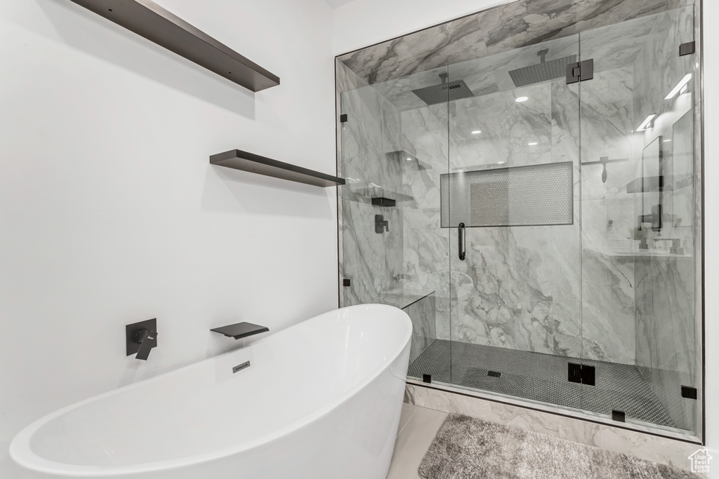 Bathroom featuring independent shower and bath and tile floors