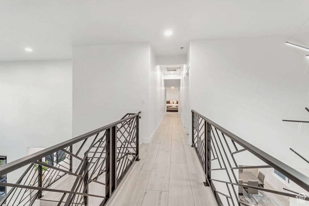 Corridor with light hardwood / wood-style flooring