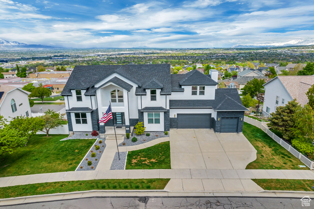 View of front of property with a garage and a front yard