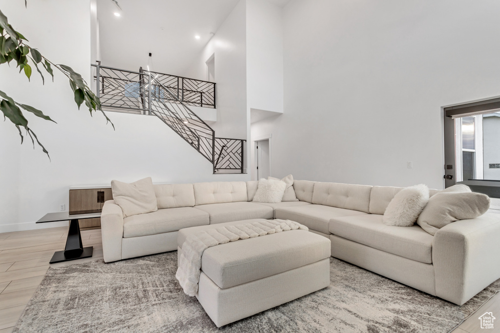 Living room with wood-type flooring and a high ceiling