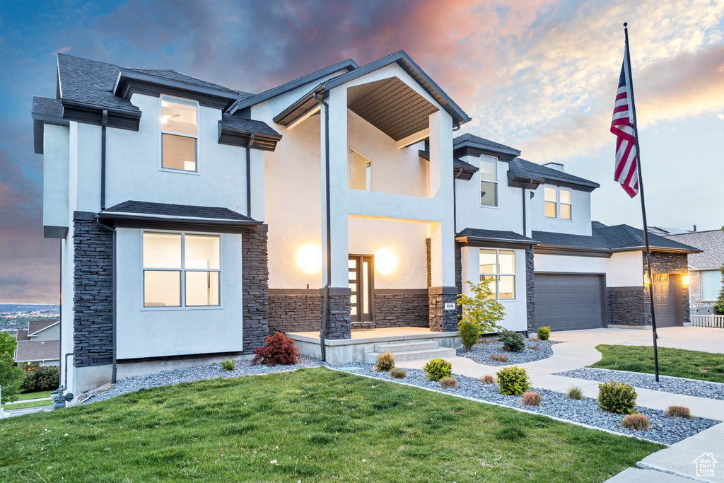 Modern home featuring a yard and a garage