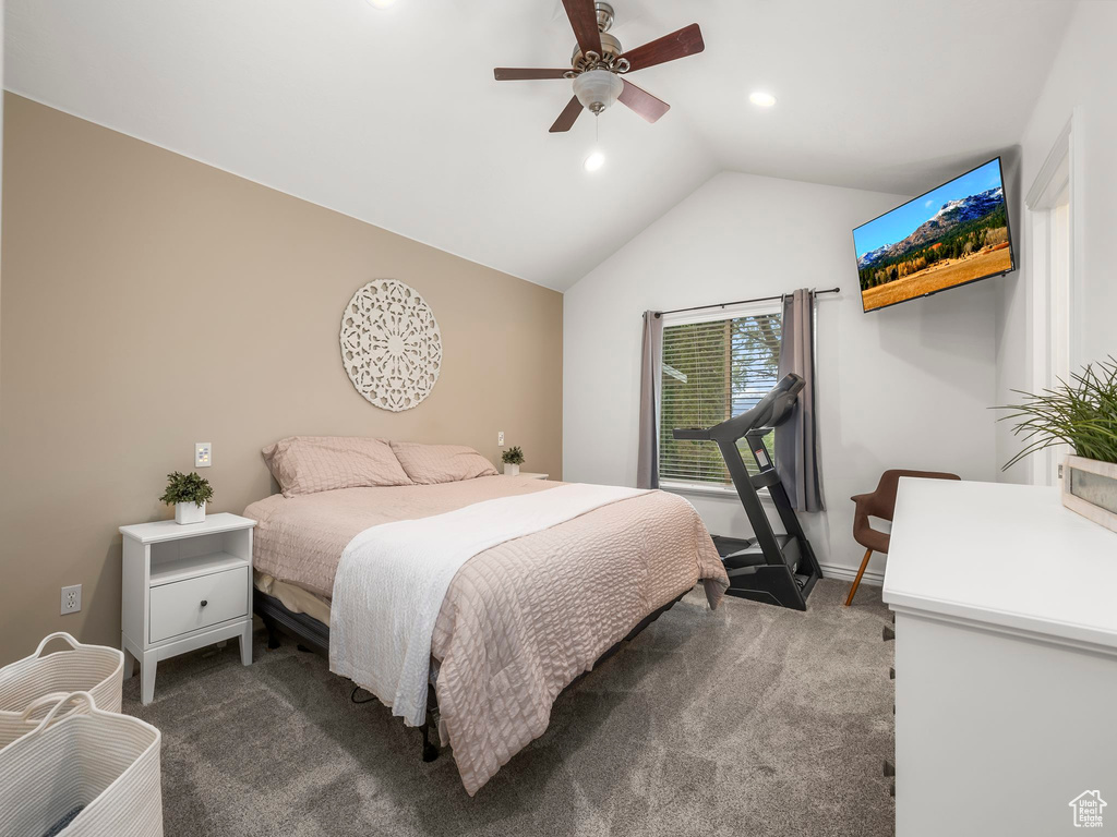 Bedroom featuring lofted ceiling, ceiling fan, and dark carpet