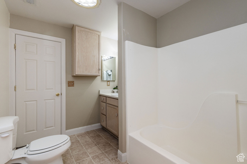 Full bathroom with shower / tub combination, vanity, toilet, and tile floors