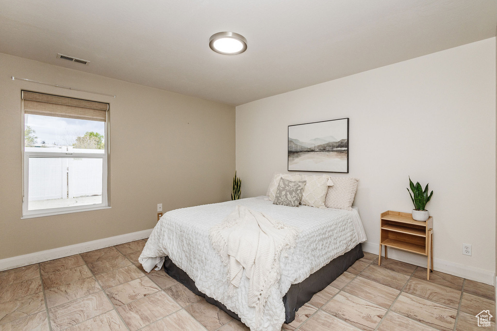 Bedroom featuring light tile flooring