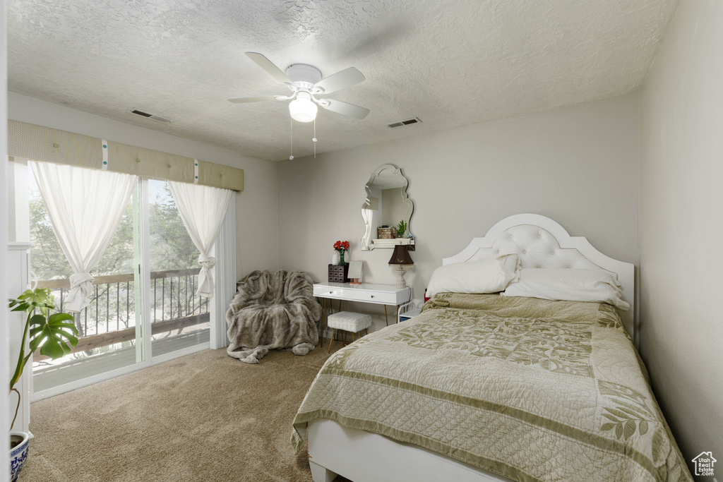Bedroom featuring ceiling fan, access to outside, carpet floors, and multiple windows