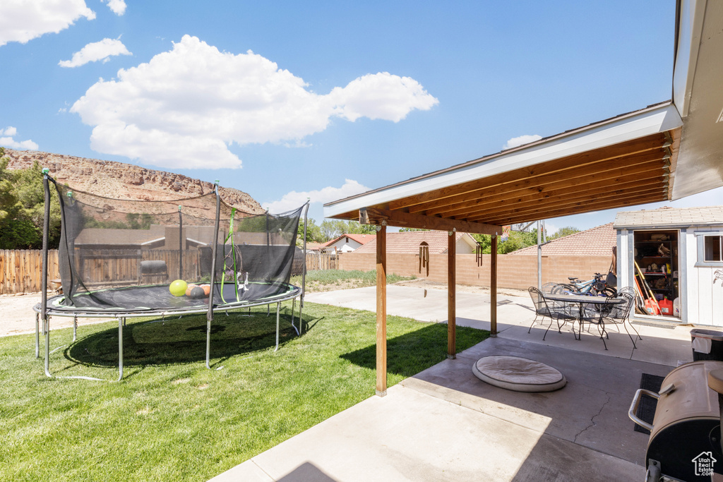 Exterior space with a patio area and a trampoline