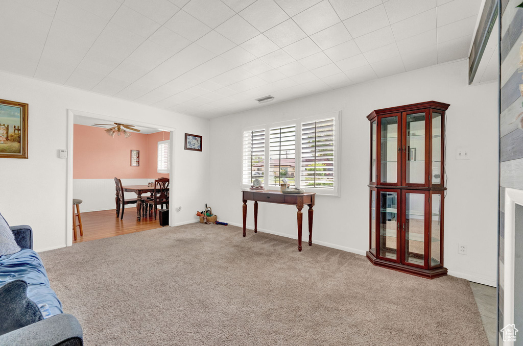 Interior space featuring ceiling fan and carpet floors