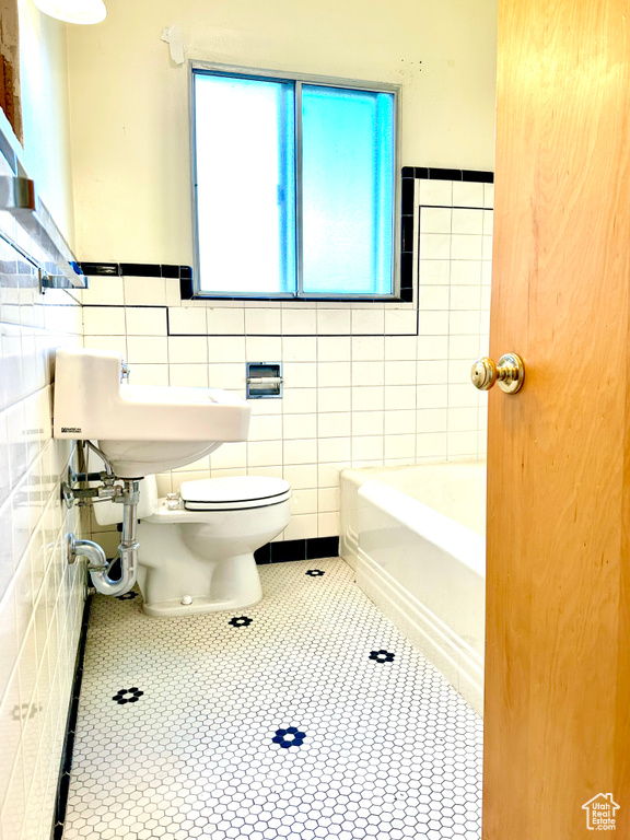 Bathroom with tile walls and tile floors