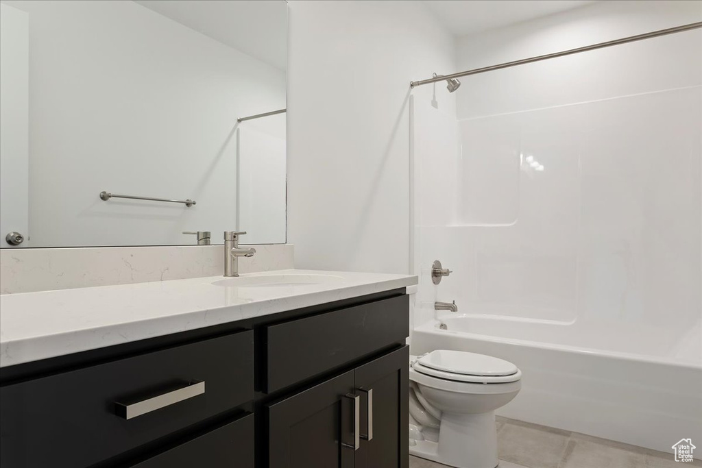 Full bathroom with tile flooring, vanity, bathtub / shower combination, and toilet