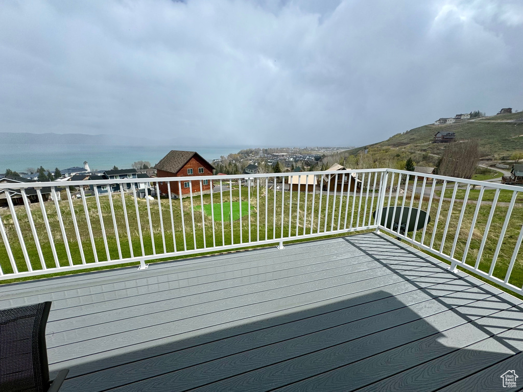 Wooden terrace featuring a yard