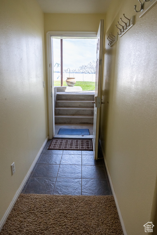 Entryway featuring dark tile floors