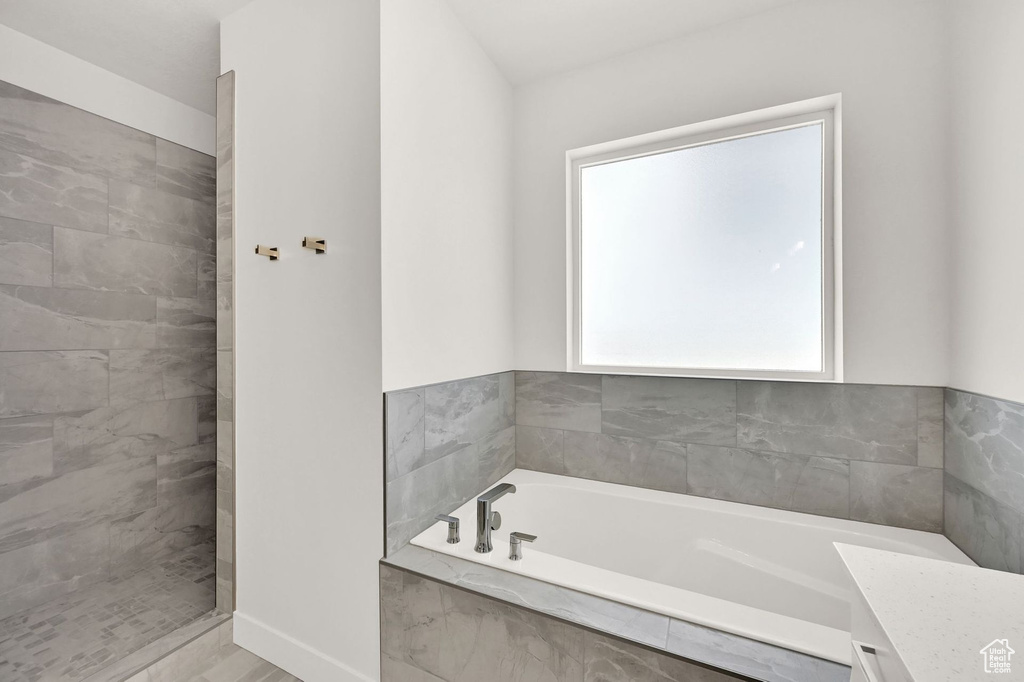 Bathroom featuring independent shower and bath and vanity