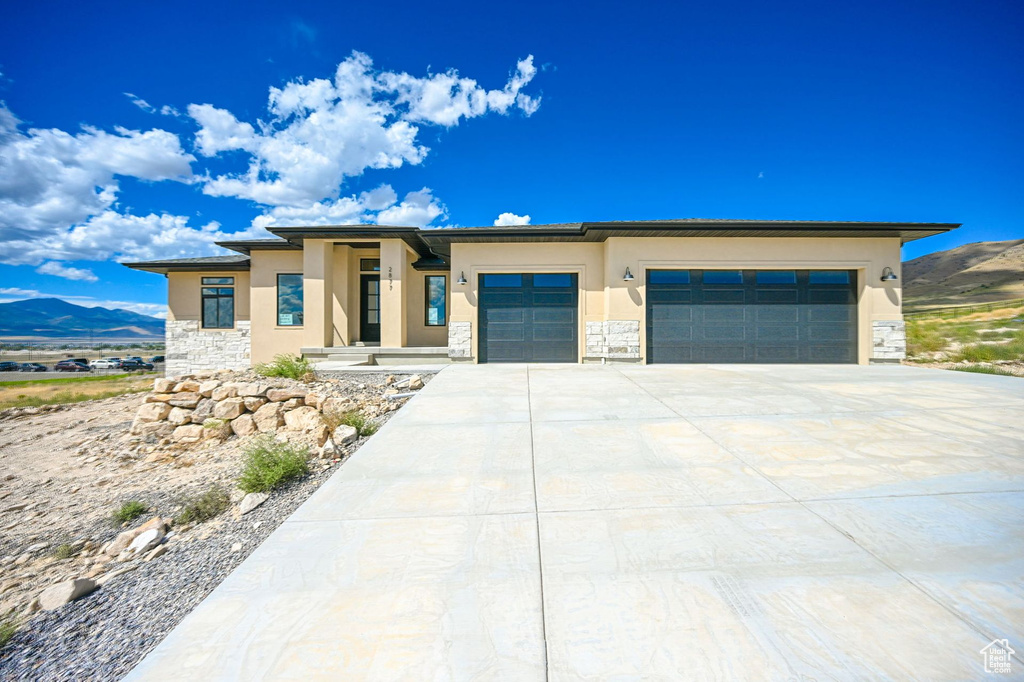 Prairie-style house featuring a mountain view and a garage