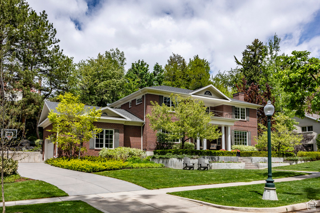 View of front of home with a garage and a front lawn