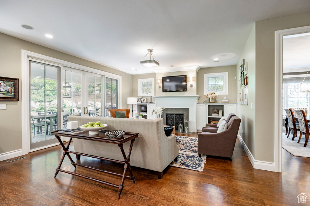 Living room featuring plenty of natural light and dark hardwood / wood-style flooring