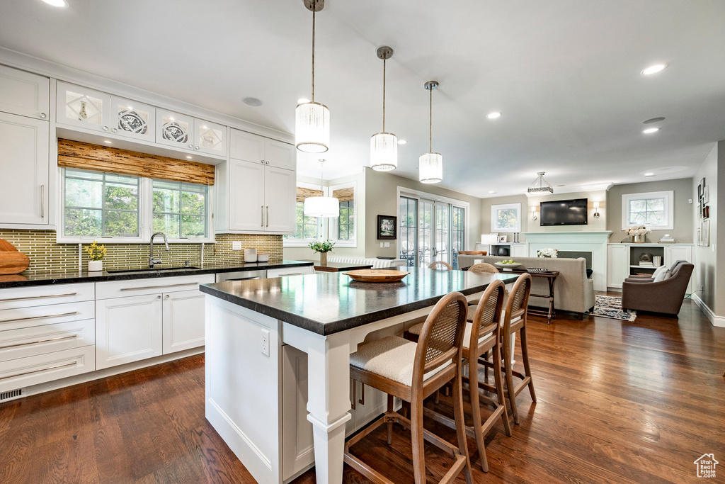 Kitchen featuring a kitchen island, dark hardwood / wood-style floors, and a healthy amount of sunlight