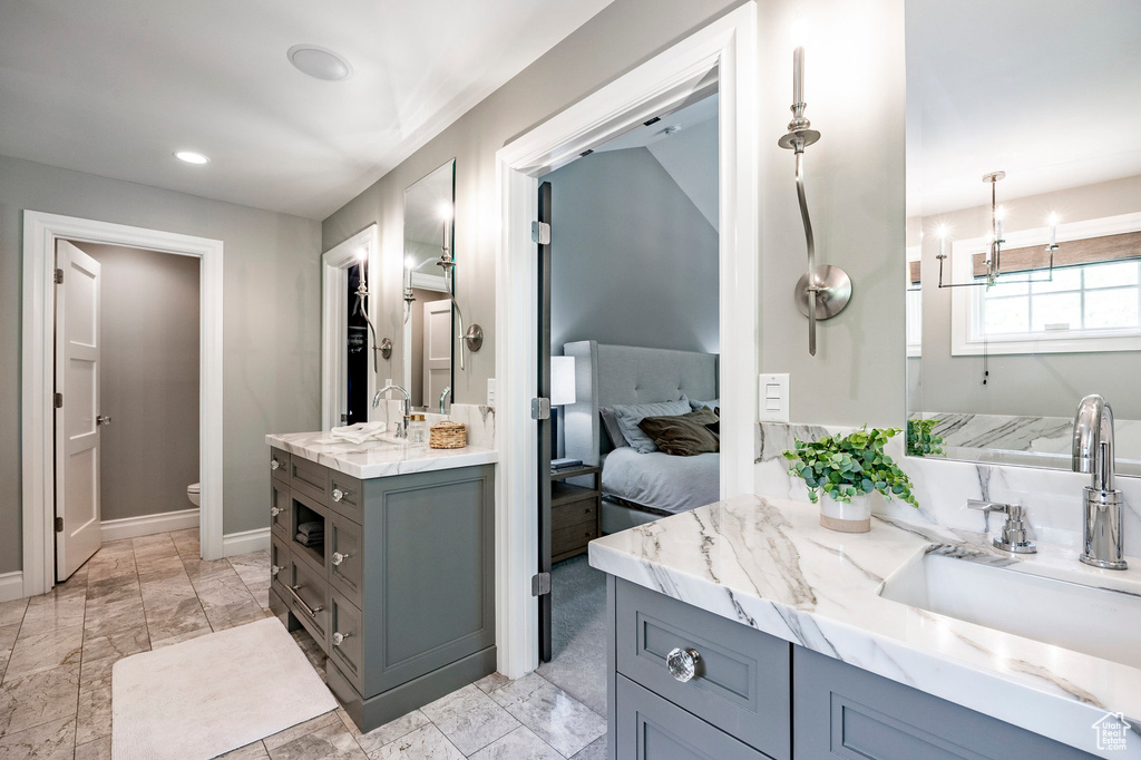 Bathroom featuring tile floors, toilet, and large vanity