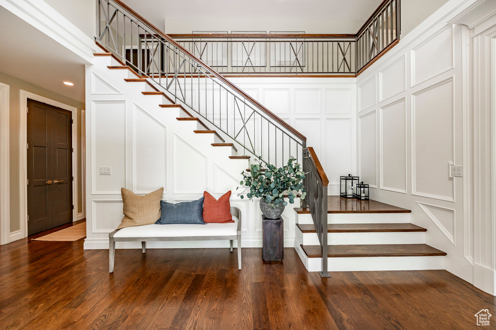 Stairway featuring hardwood / wood-style flooring