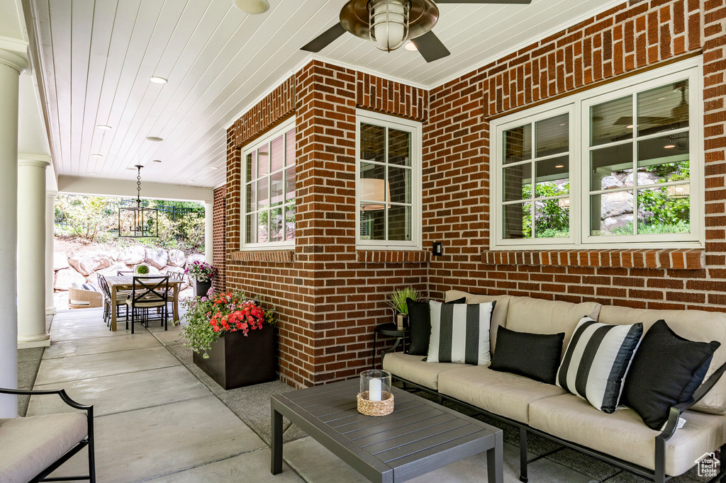 View of terrace with ceiling fan and outdoor lounge area