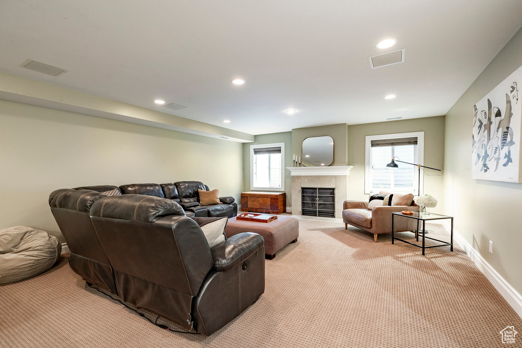 Carpeted living room with a tile fireplace