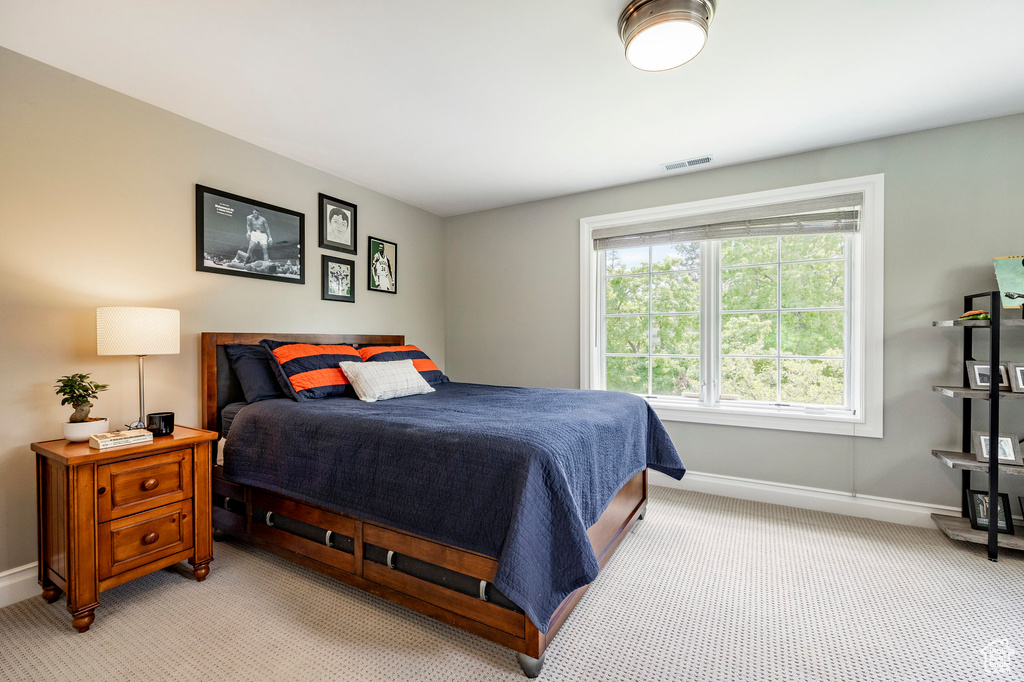 Bedroom featuring light colored carpet