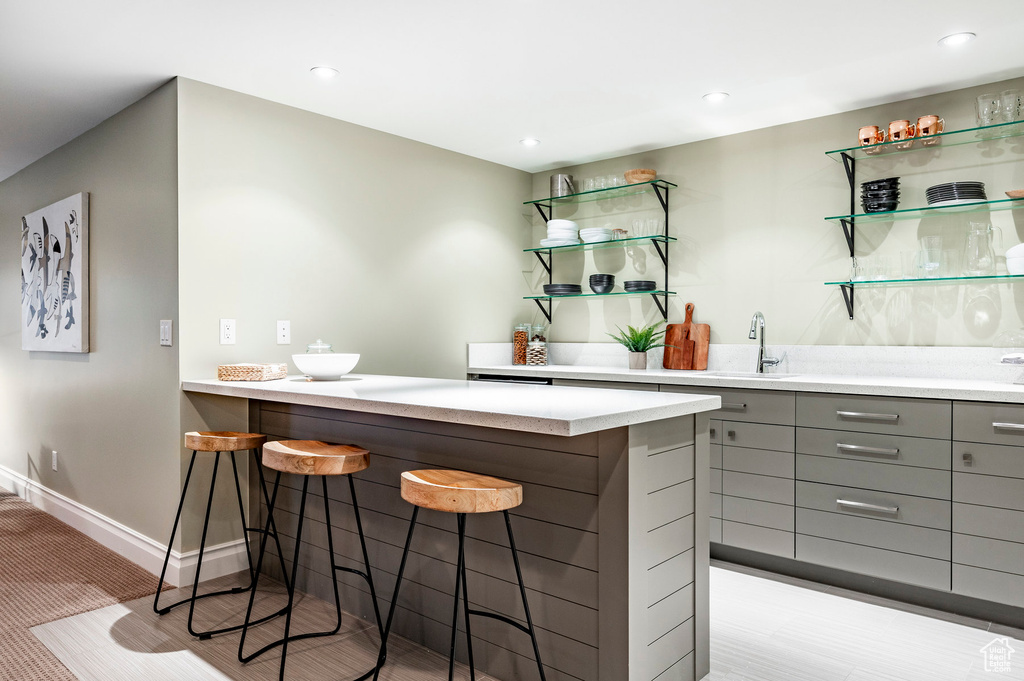 Bar featuring gray cabinetry and sink