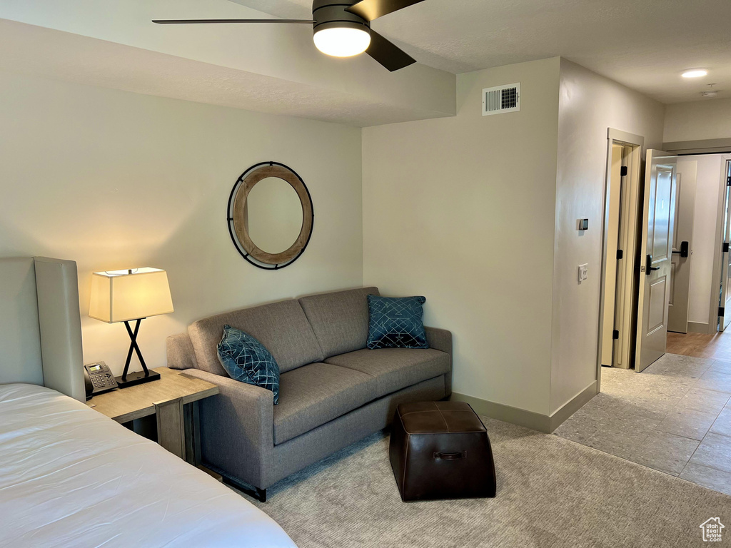 Carpeted bedroom with ceiling fan