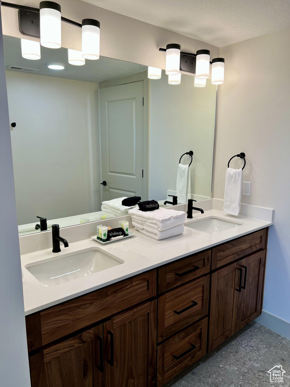 Bathroom featuring dual bowl vanity