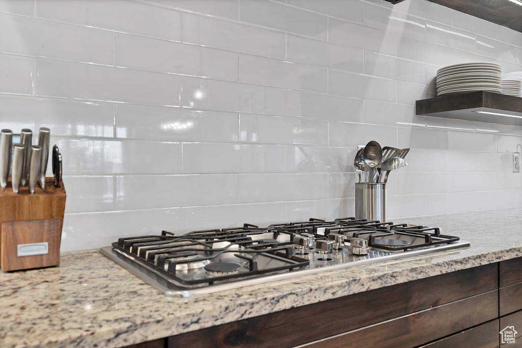 Details with backsplash and stainless steel gas stovetop
