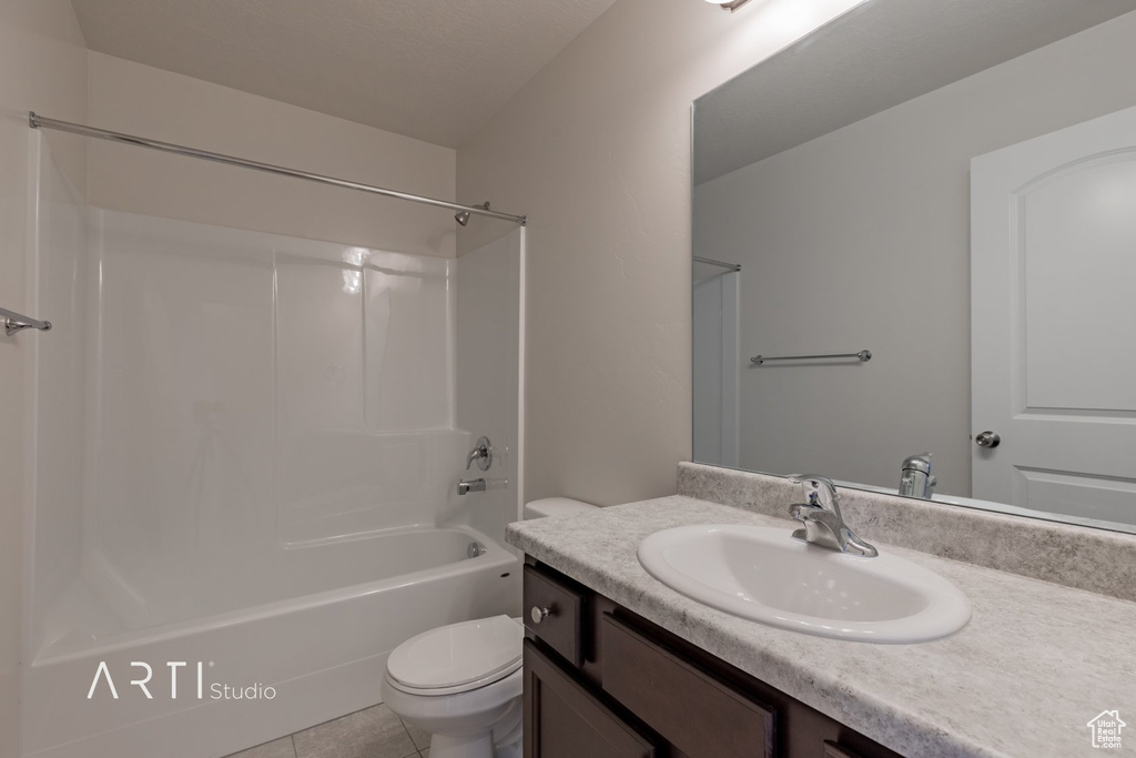 Full bathroom featuring tile floors,  shower combination, toilet, and oversized vanity