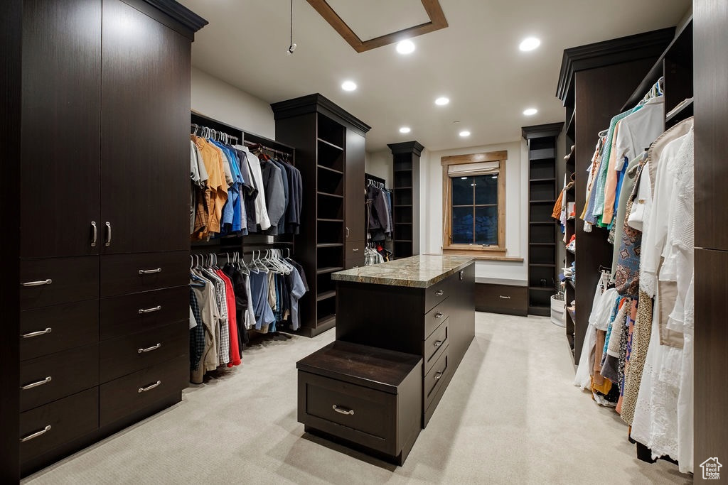 Walk in closet featuring light carpet