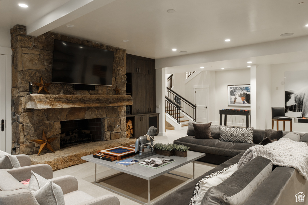 Living room featuring stairway, a fireplace, and recessed lighting