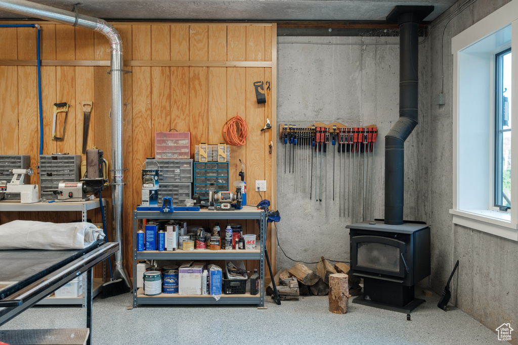 Basement with a wood stove and healthy amount of natural light