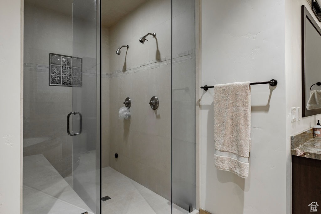 Bathroom featuring an enclosed shower and vanity