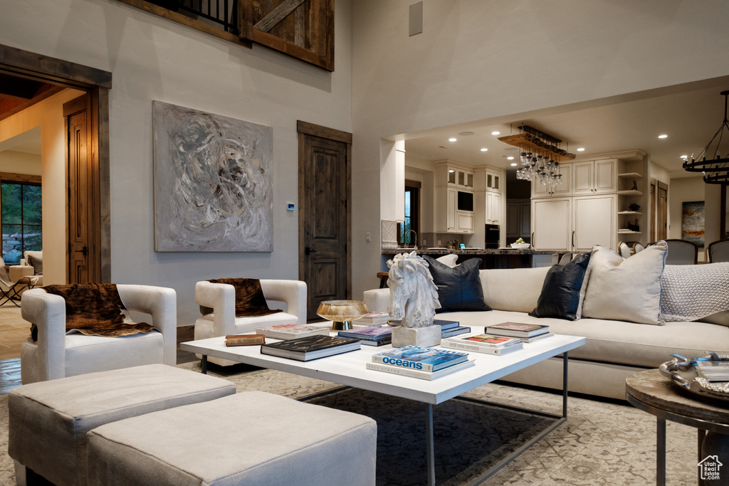 Living room featuring a chandelier and a high ceiling