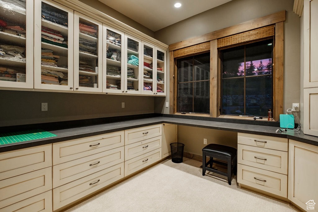 Unfurnished office with built in desk and light colored carpet