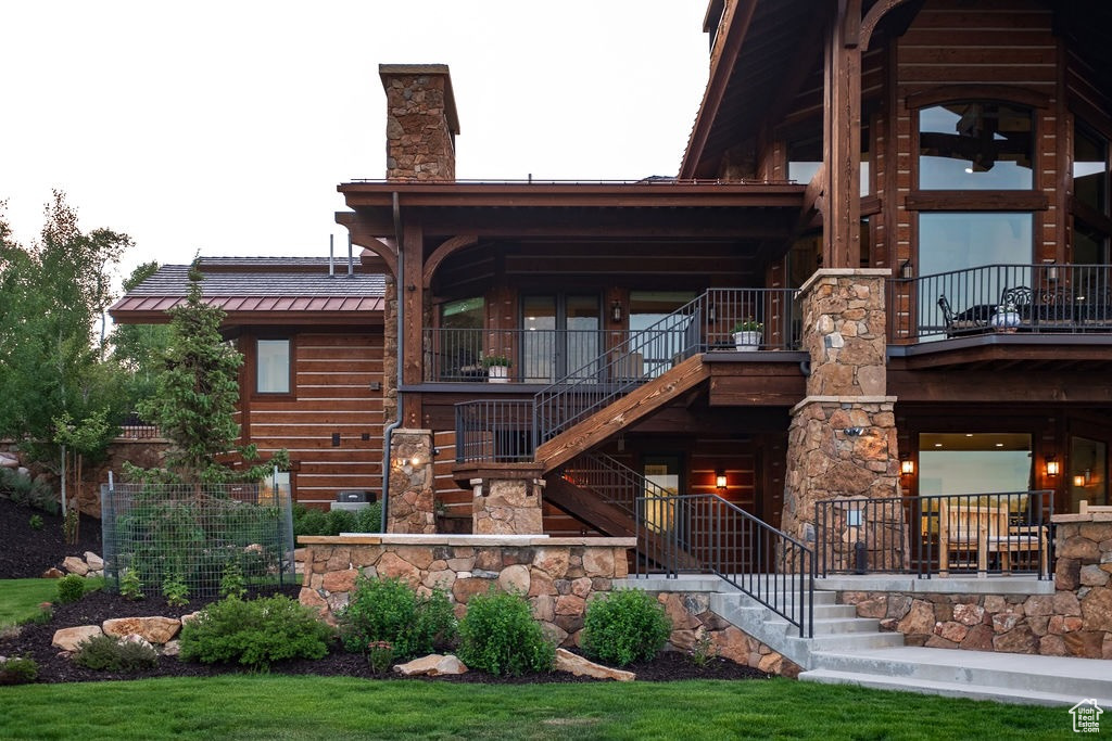 Exterior space featuring a balcony and a lawn