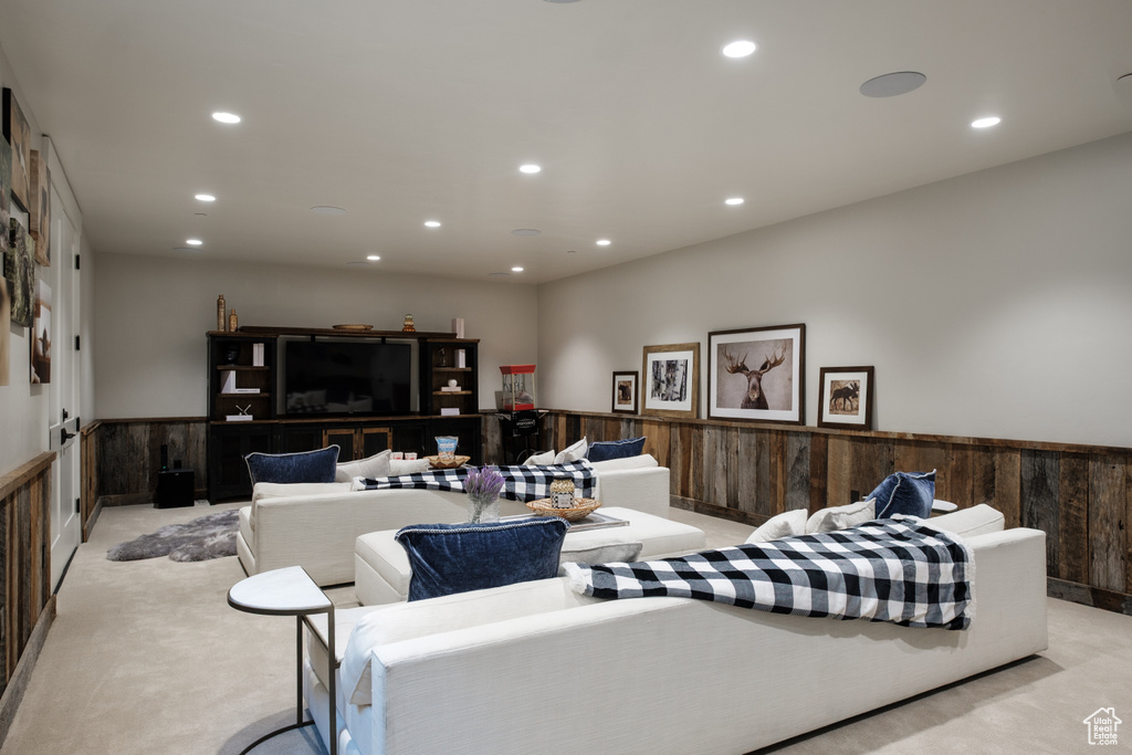 Living room featuring recessed lighting, a wainscoted wall, and light carpet