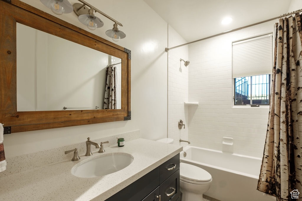 Full bathroom with vanity, toilet, and shower / tub combo