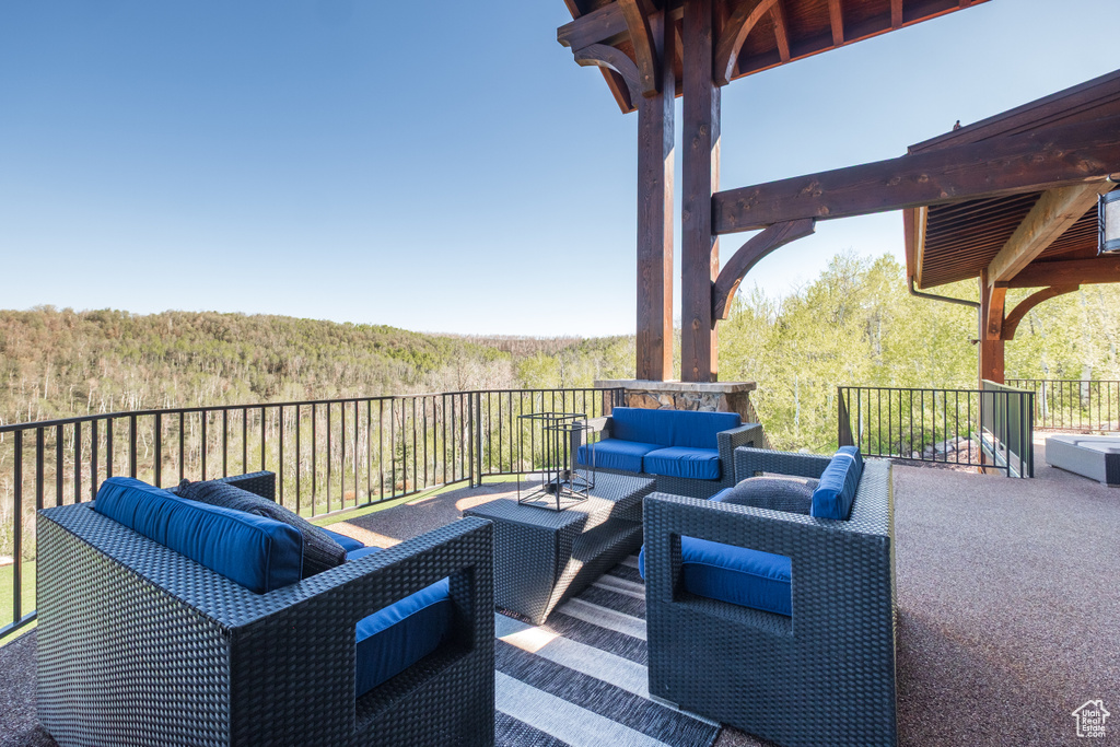 View of patio / terrace with an outdoor hangout area and a forest view