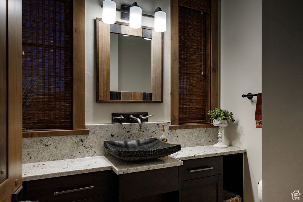 Bathroom featuring oversized vanity and toilet