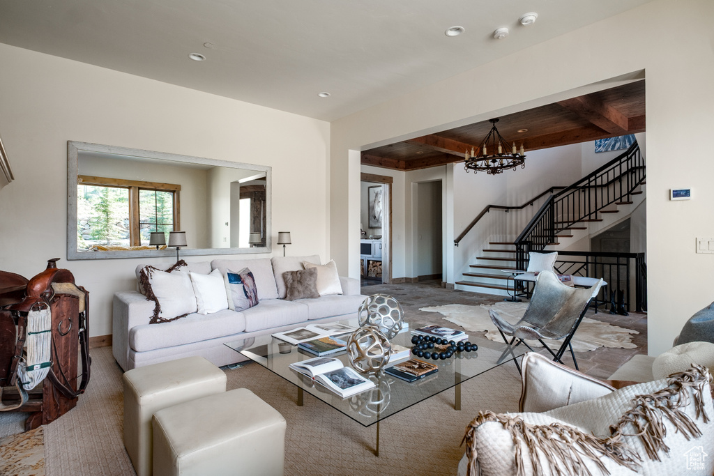 Living area with stairs, a chandelier, beamed ceiling, and recessed lighting