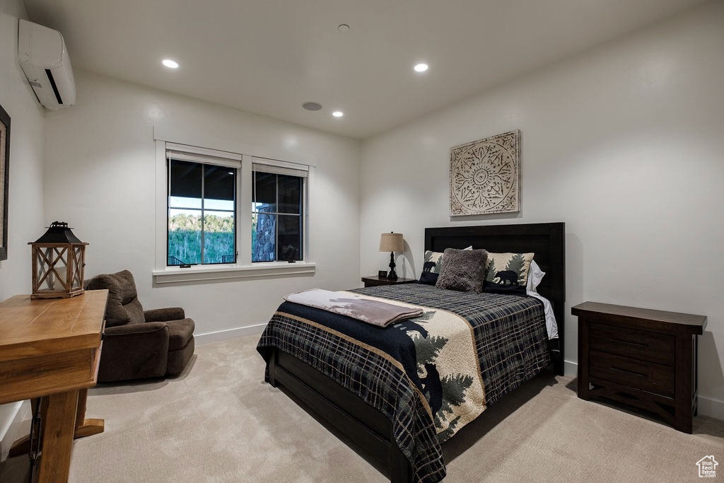 Carpeted bedroom featuring a wall unit AC