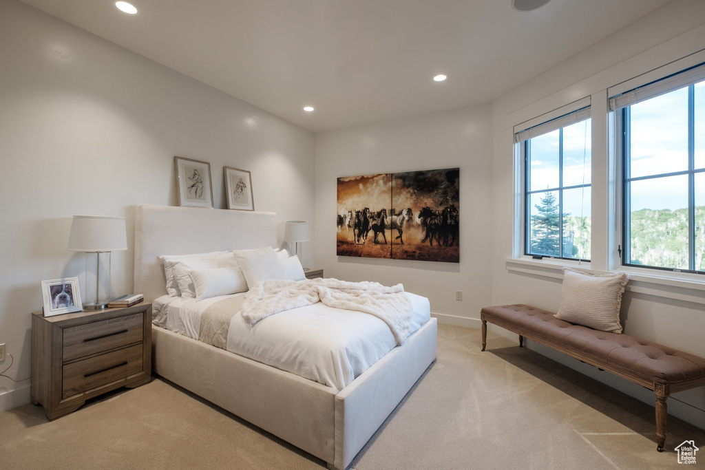 Bedroom with light colored carpet and recessed lighting