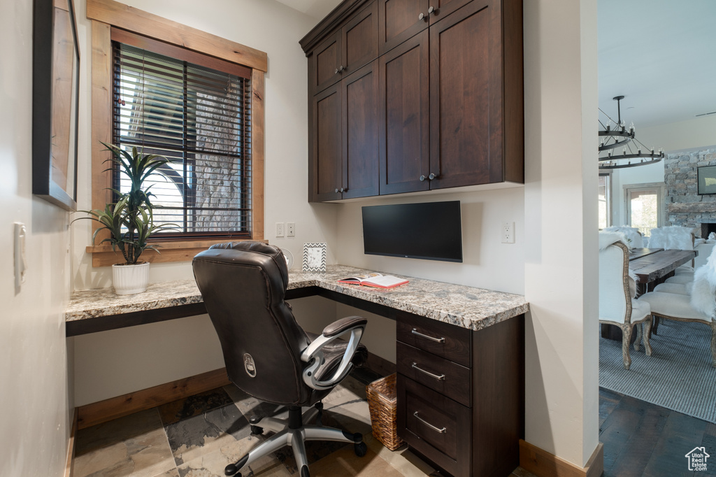 Home office featuring built in study area and baseboards