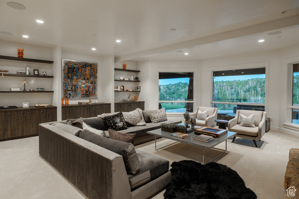 Living room with light carpet, recessed lighting, and plenty of natural light