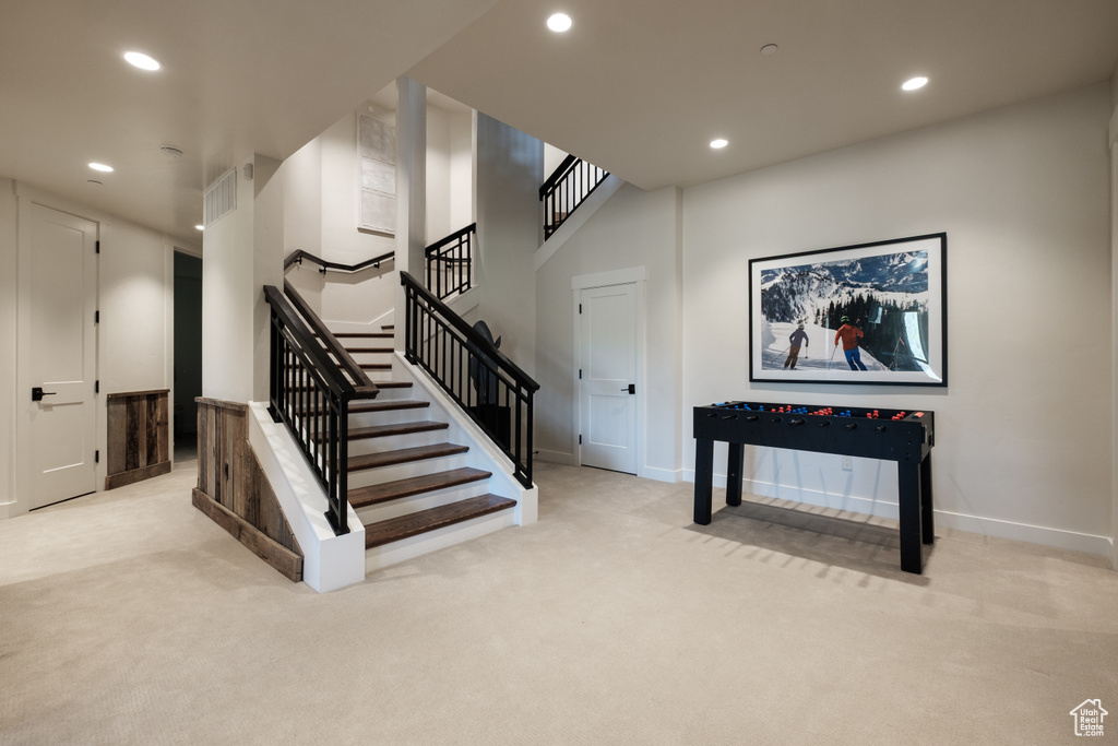 Stairs with recessed lighting and carpet