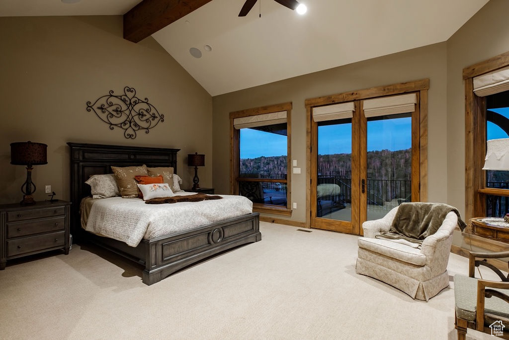 Bedroom with carpet, ceiling fan, vaulted ceiling with beams, and access to outside